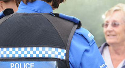 A police officer talking to a member of the public.